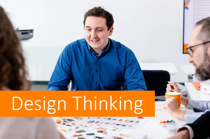 Team bei Design Thinking Workshop in Besprechungsraum.